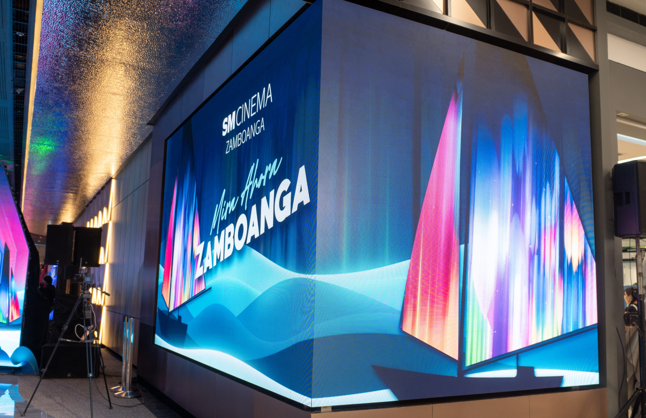 A large corner-mounted LED display screen showcasing vibrant digital graphics.