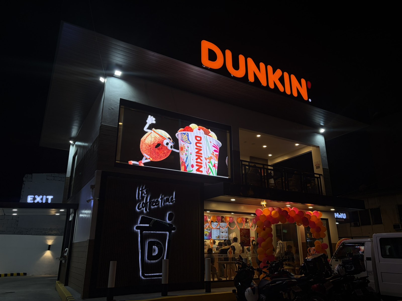 A Food Franchise Place With A Transparent LED Display Lighting Up The Night